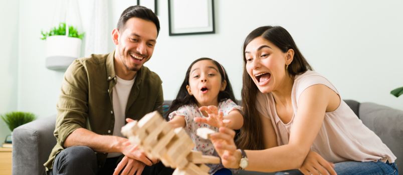 Family laughing losing board game