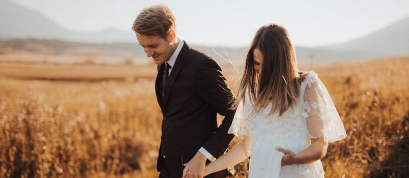 Coupe walking in field