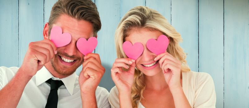 Attractive couple holding hearts