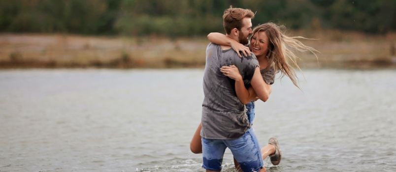 Couple hugging in water