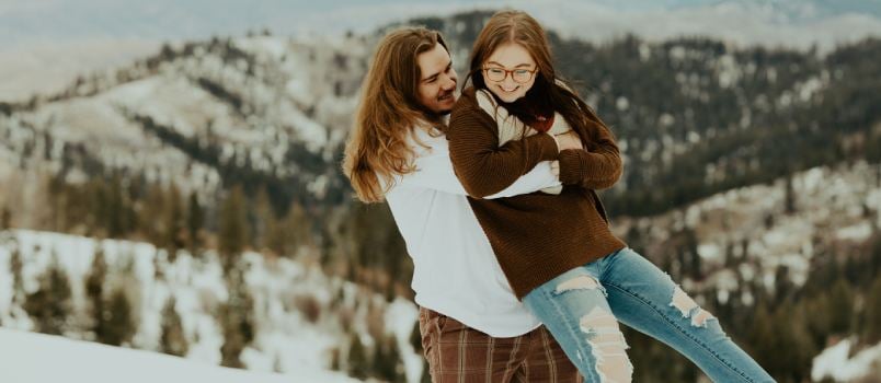 Couple hugging standing on the mountain
