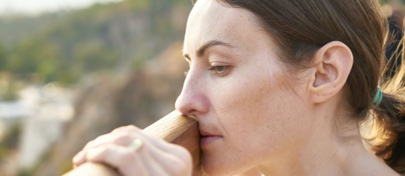 Woman standing in front of wood plank