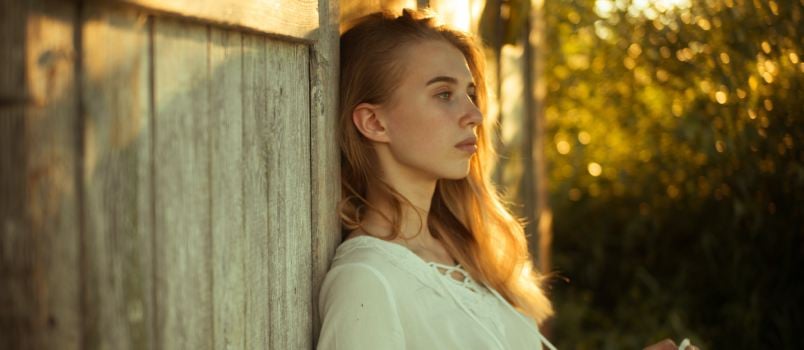 Woman leaning on wall