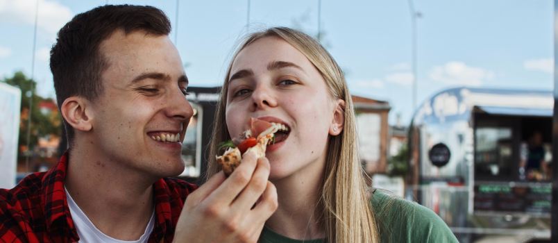 Man feeding her woman