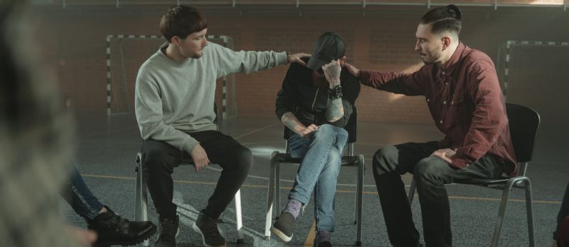 Man consoling a member of group