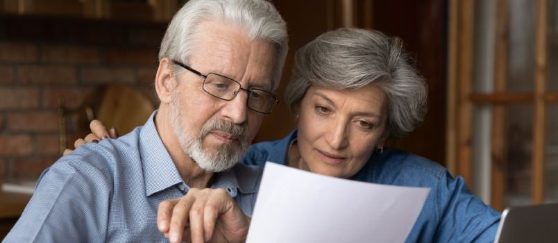 Elder couple reading paper