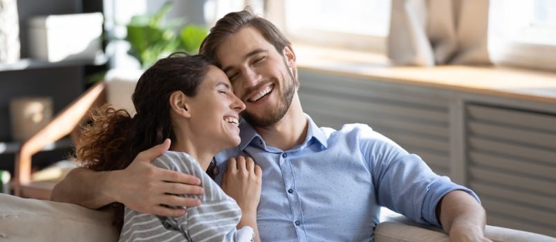 Happy couple laying on couch
