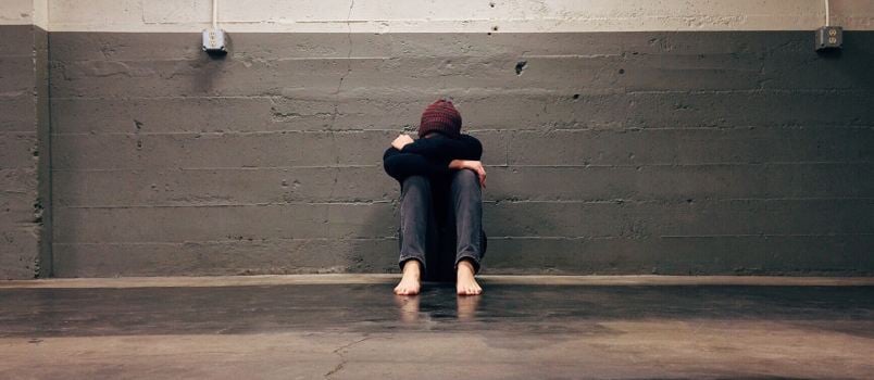 alone man sitting on floor