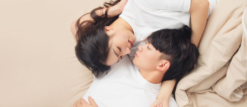 Young asian couple laying