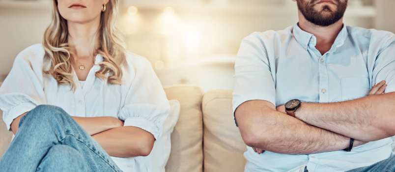 Couple sitting on couch not talking with each other