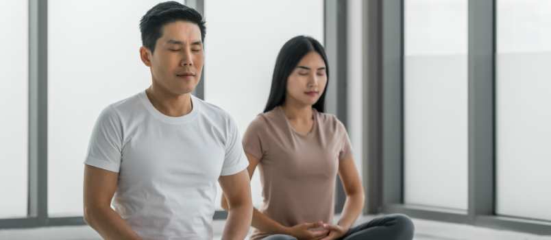 Asian couple sitting on meditation