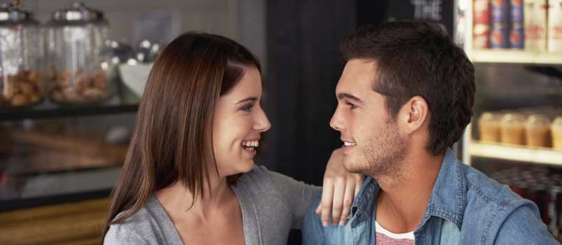 Young couple talking together in cafe