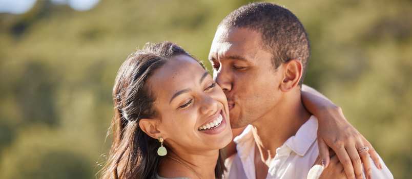 Young man kissing his wife