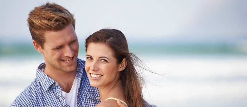 Young couple embracing near the beach