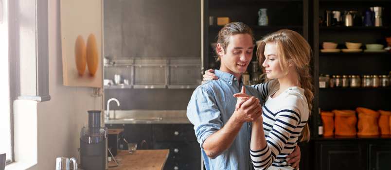 Young couple dancing in kitchen
