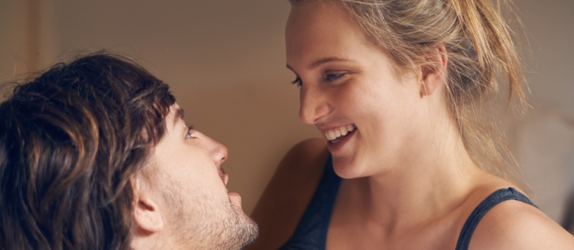 Young couple talking in bed