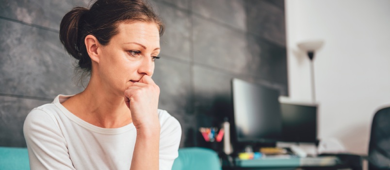 Sad woman sitting on couch