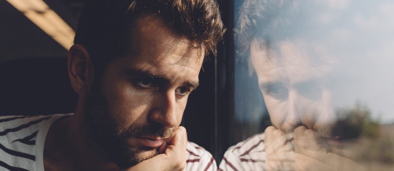 Sad man looking through out the window