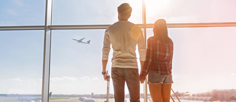 Young couple travelling holding map