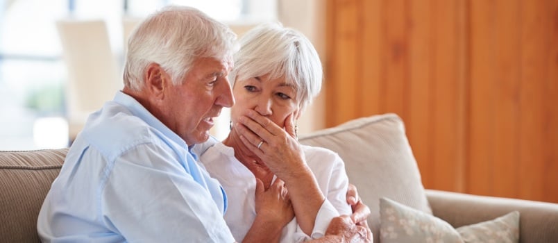 Woman consoling senior man