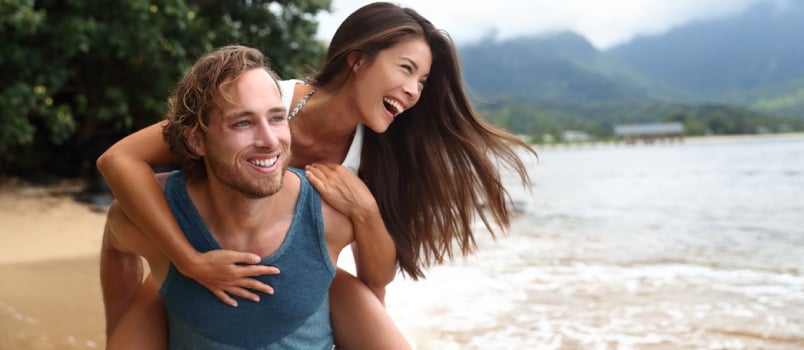 Two young people playing near beach