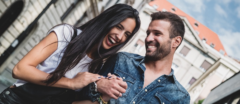 Couple laughing holding hands