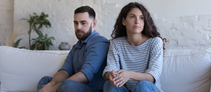 Silent couple sitting on couch