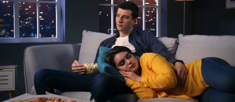 Young woman sleeping on her husband lap