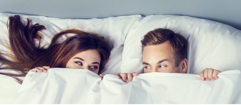 attractive couple peeping bedsheet