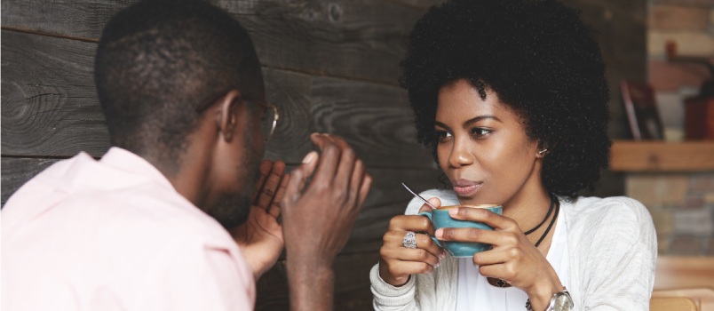 Black girl holding cup of coffee