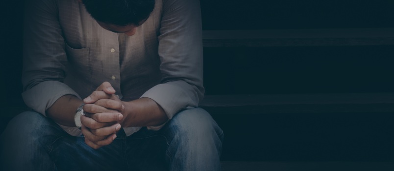 Sad man sitting alone