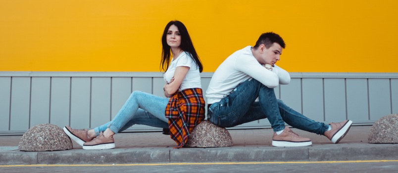 Young couple sitting back