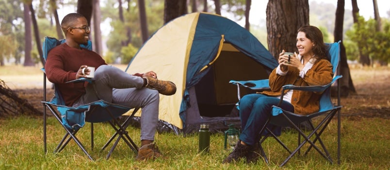 Young couple camping outside