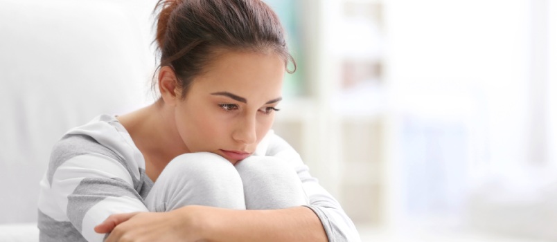 Young woman sitting on the floor