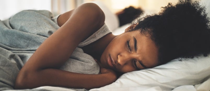 Sad woman laying on bed