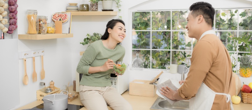 Happy couple eating in kitchen