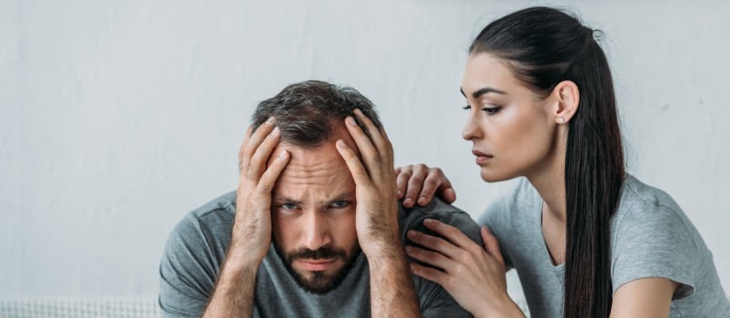 Young woman supporting depressed man