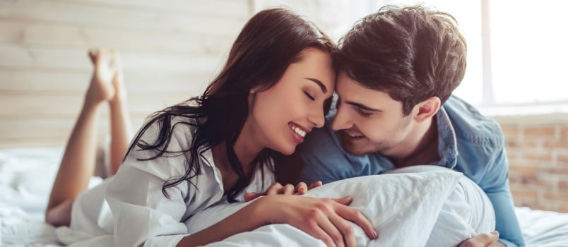 Young couple laying in bedroom