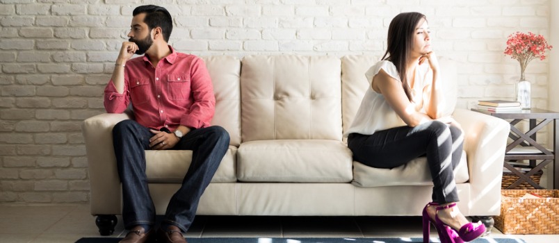 Husband and wife sitting on couch