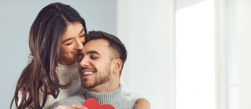 Couple giving heart to each other