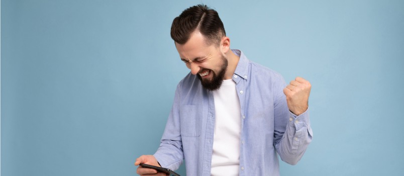 Man looking in smartphone and laughing