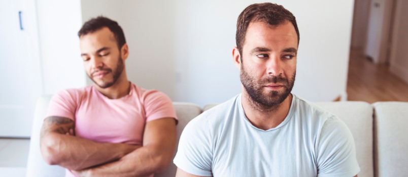 Gay couple sitting on couch