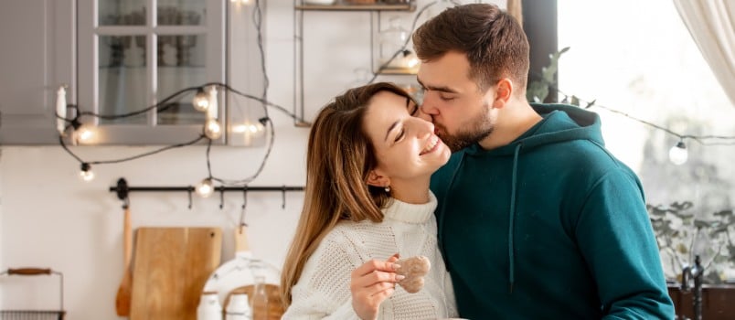 Happy couple baking in kitchen