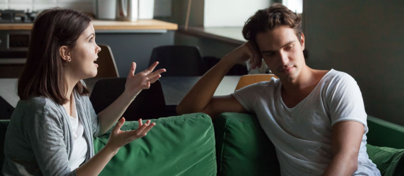 Young attractive couple sitting on couch