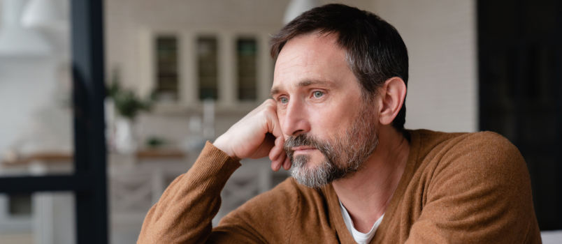 Sad man looking outside