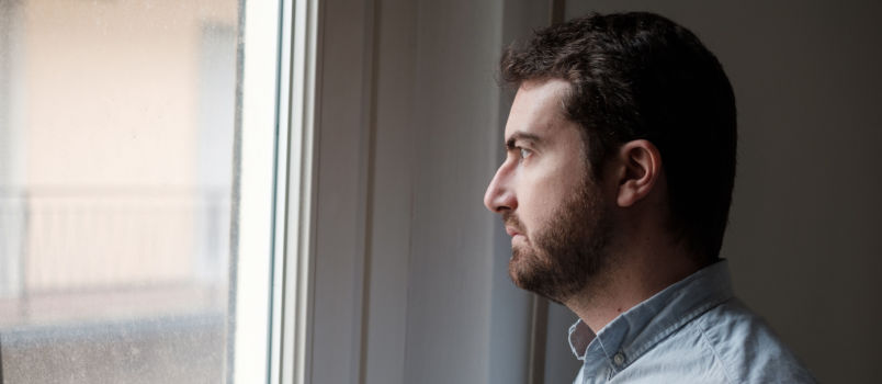 Man looking outside of the window