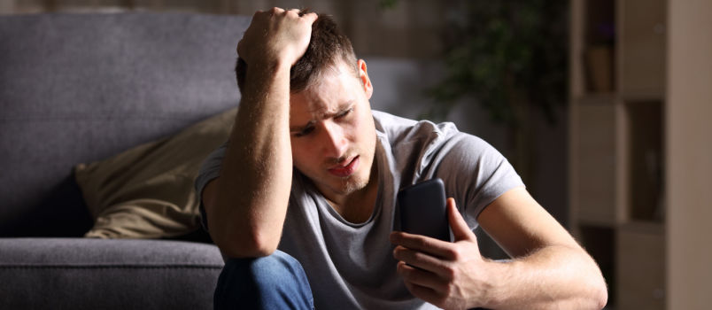 Sad man looking outside the window