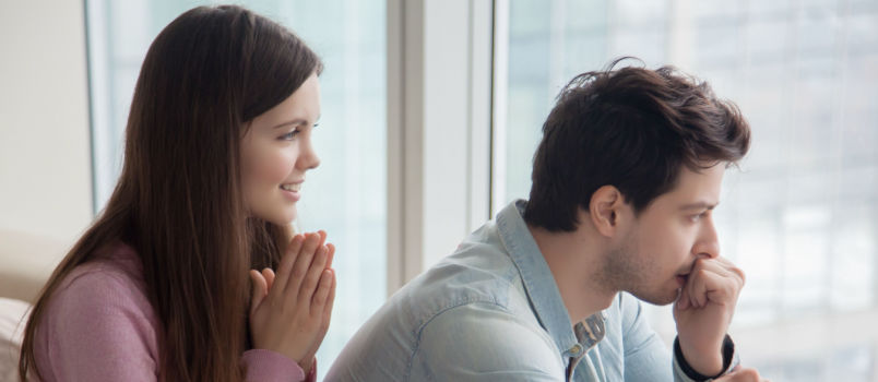 Woman apologizing upset man