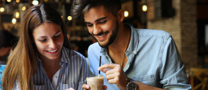 Woman and man flirting in cafe