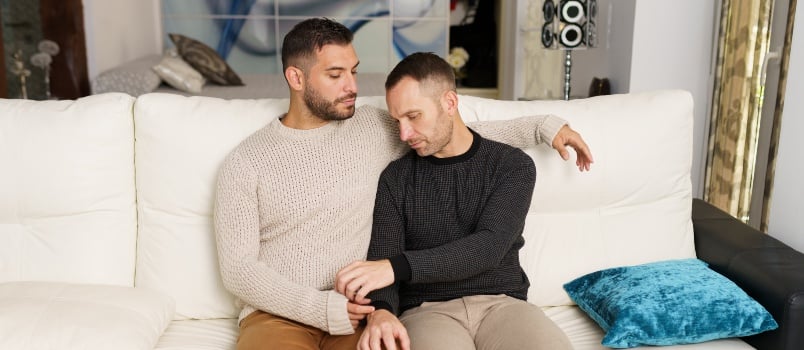 Gay couple chilling on couch